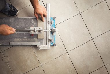 top-view-of-a-construction-worker-cutting-a-tile-using-a-tile-cutting-machine